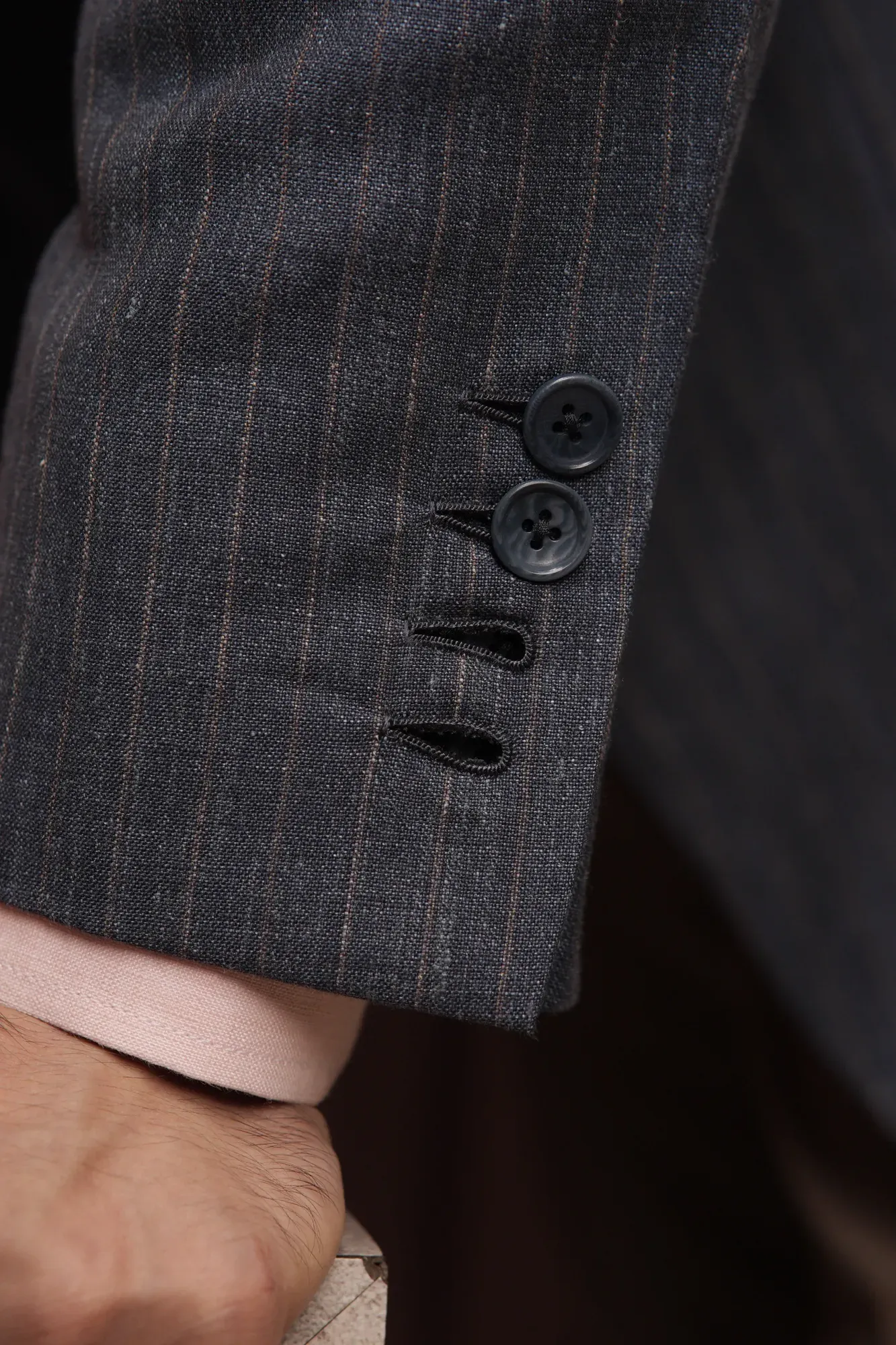 Four buttons on a jacket sleeve