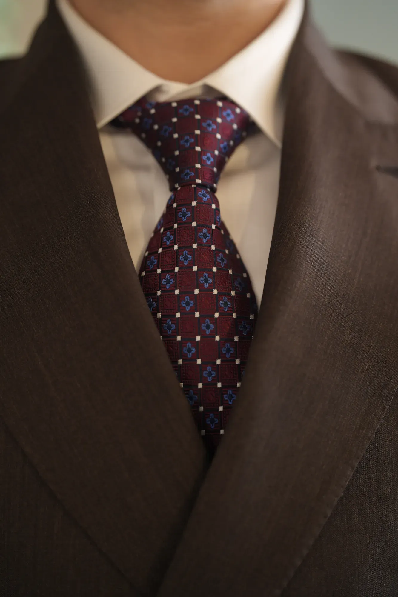 A silk tie knotted beneath a spread collar