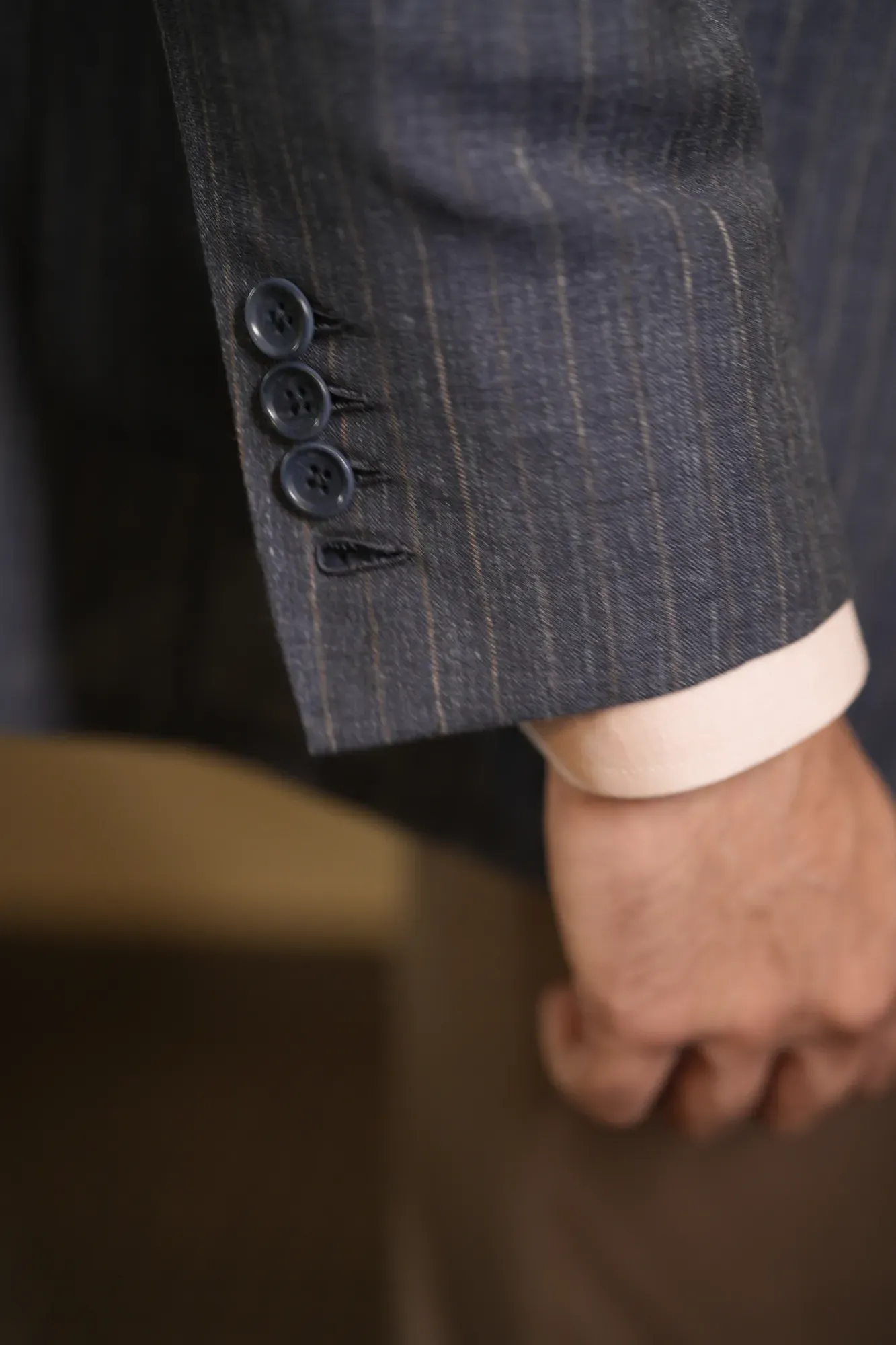 A jacket cuff falling over a shirt cuff